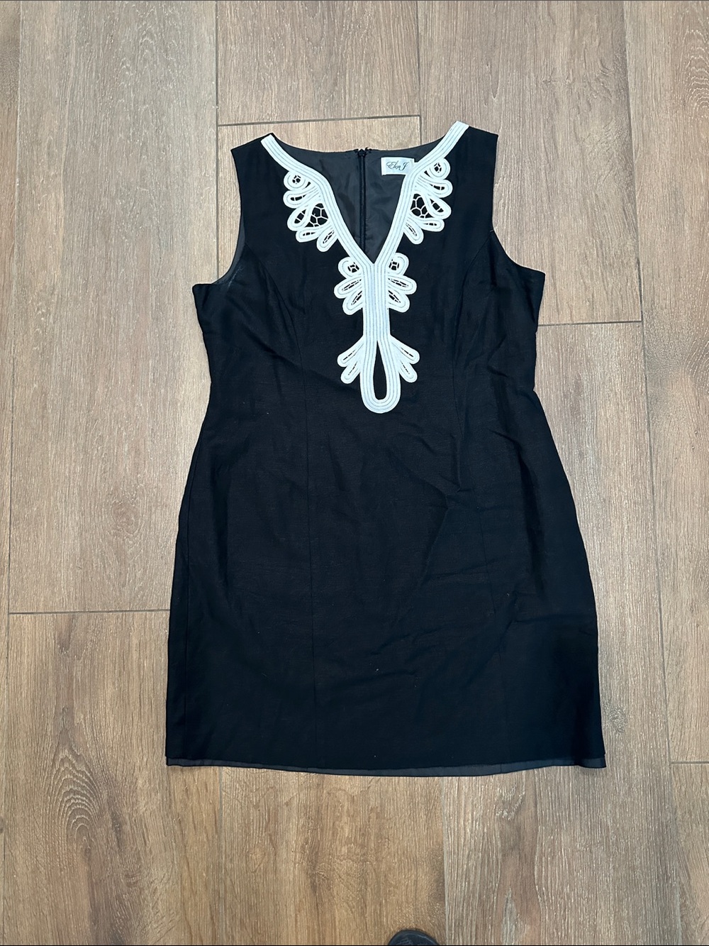 Black Sleeveless Mini Dress with White Embroidered V-Neck